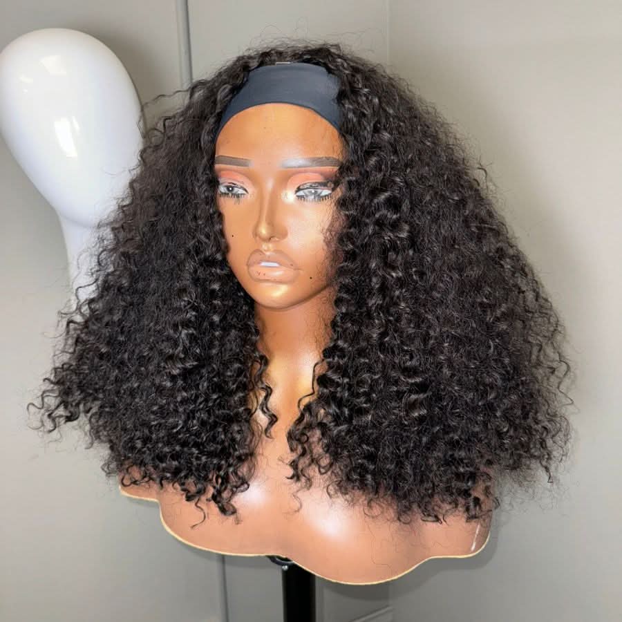 Mannequin head with black headband wearing long black curly half wig